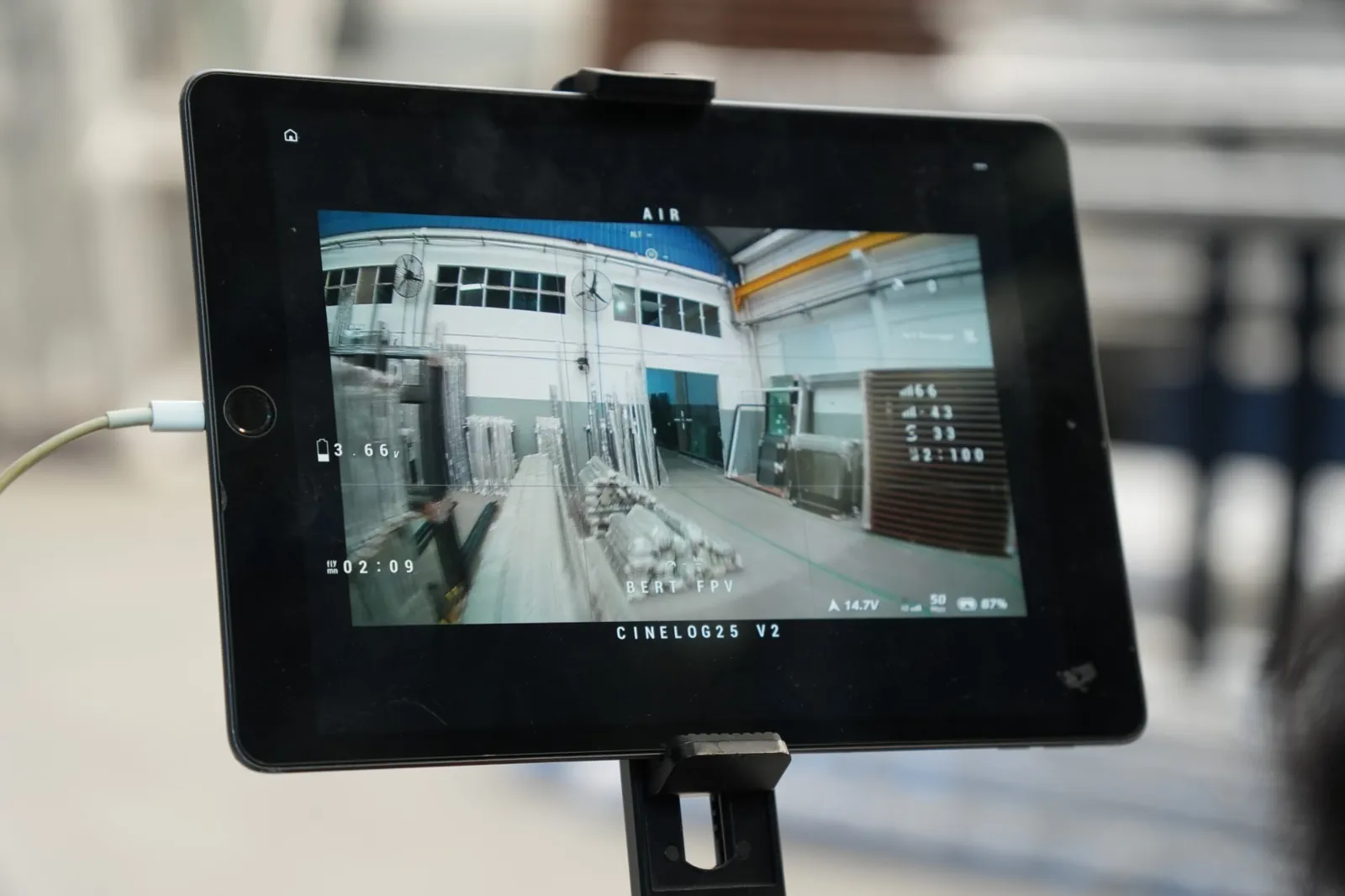 Tela do FPV mostrando o voo dentro de um galpão industrial